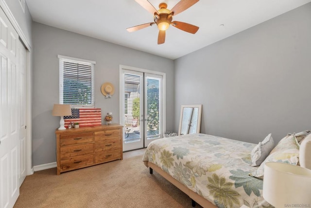 carpeted bedroom with access to outside, a closet, and ceiling fan