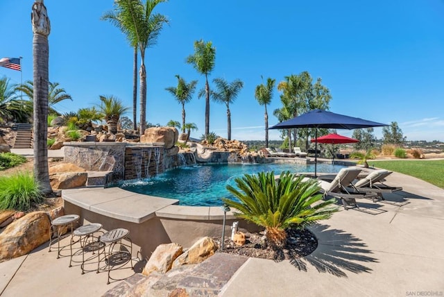 view of pool featuring pool water feature and an outdoor bar