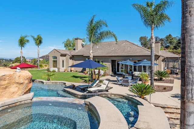 view of swimming pool with a patio area, an in ground hot tub, and a yard