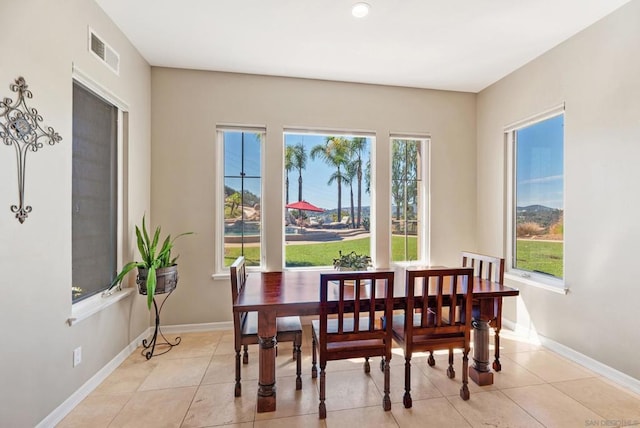 dining space featuring light tile patterned flooring