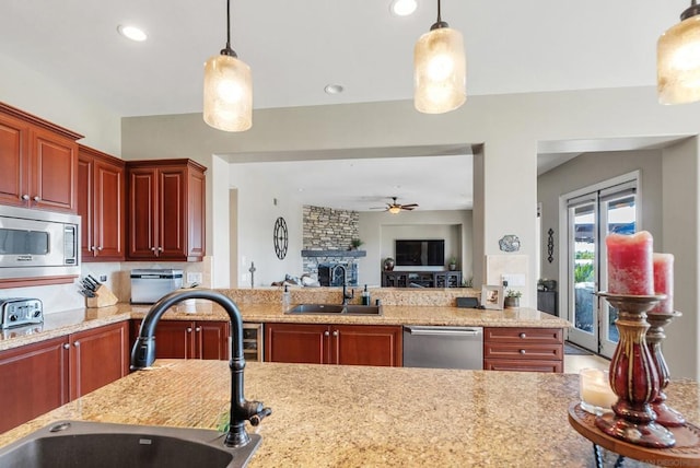 kitchen featuring ceiling fan, sink, pendant lighting, and appliances with stainless steel finishes