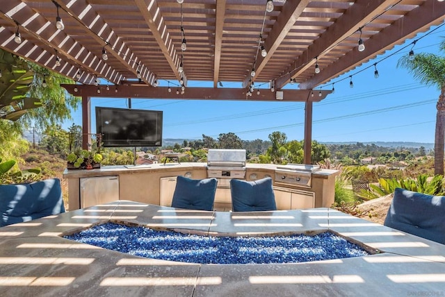 view of patio / terrace with an outdoor kitchen, area for grilling, and a pergola