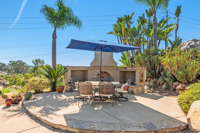 view of patio / terrace featuring exterior fireplace