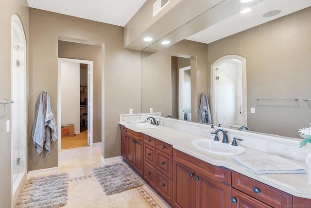 bathroom with tile patterned flooring, vanity, and an enclosed shower