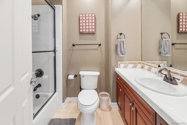 full bathroom featuring tile patterned floors, vanity, toilet, and enclosed tub / shower combo