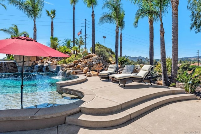 view of swimming pool with pool water feature