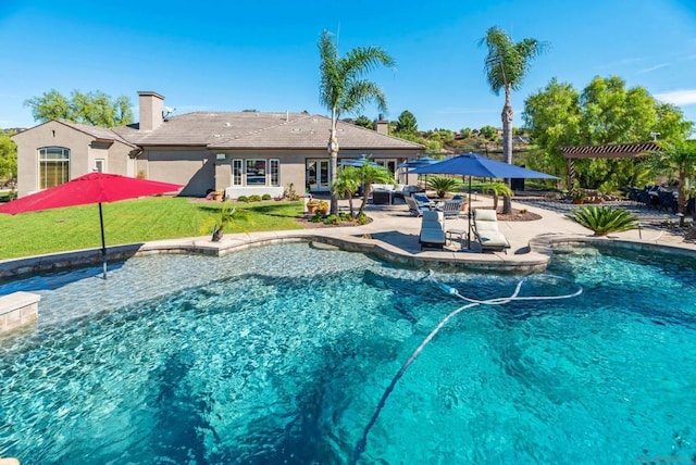 view of swimming pool featuring a yard and a patio