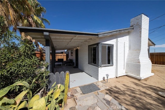 view of side of property featuring a patio area