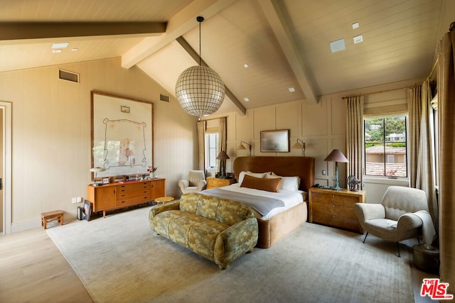 bedroom featuring vaulted ceiling with beams and light wood-type flooring