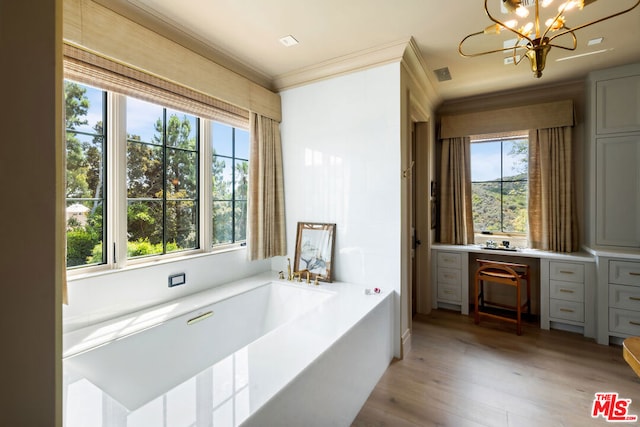 interior space with gray cabinetry, plenty of natural light, crown molding, and light wood-type flooring