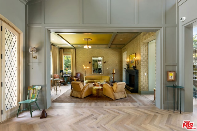 living room with a notable chandelier and light parquet floors