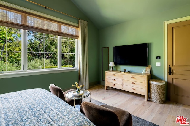 bedroom with vaulted ceiling and hardwood / wood-style floors