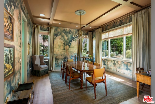 dining area featuring coffered ceiling, a healthy amount of sunlight, beam ceiling, and wood-type flooring