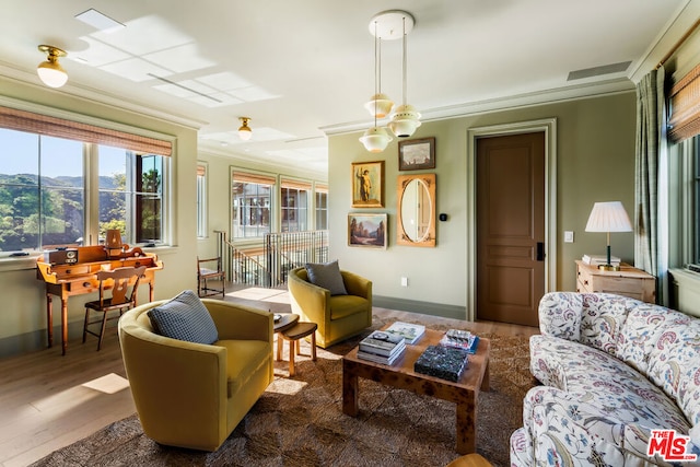 sitting room with dark hardwood / wood-style floors and crown molding