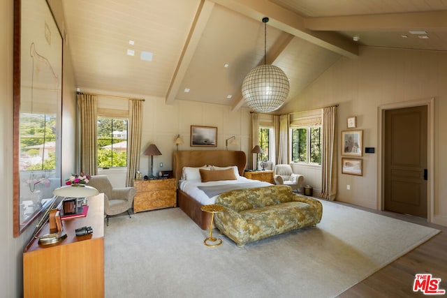 bedroom featuring wood-type flooring, vaulted ceiling with beams, and multiple windows