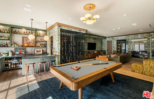 game room with crown molding, light hardwood / wood-style flooring, bar area, and billiards