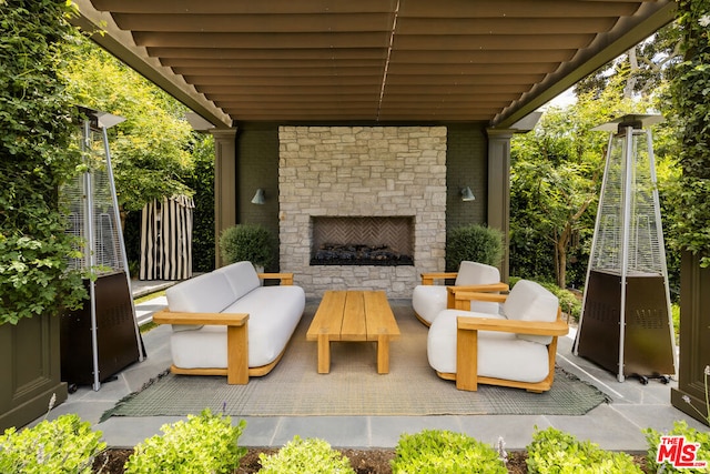 view of patio / terrace with an outdoor stone fireplace