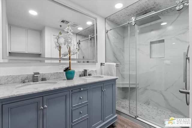 bathroom featuring vanity, a shower with shower door, and hardwood / wood-style flooring