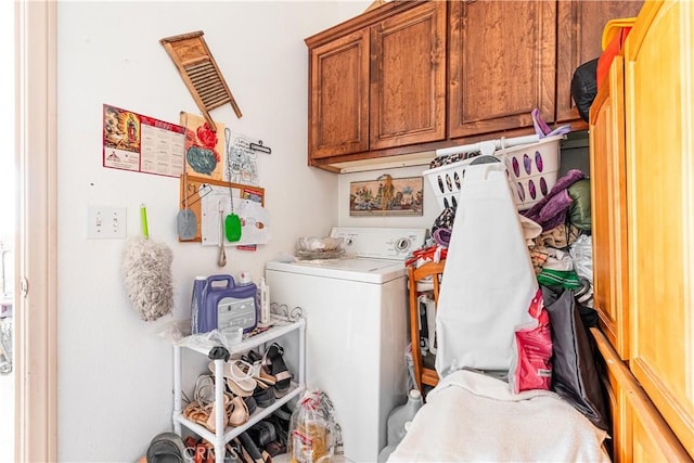 washroom with cabinets and washer / dryer