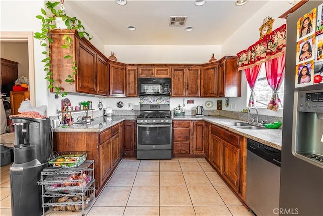 kitchen featuring light tile patterned flooring, stainless steel appliances, and sink