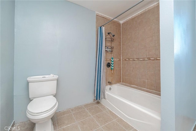 bathroom featuring tile patterned flooring, toilet, and shower / bathtub combination with curtain