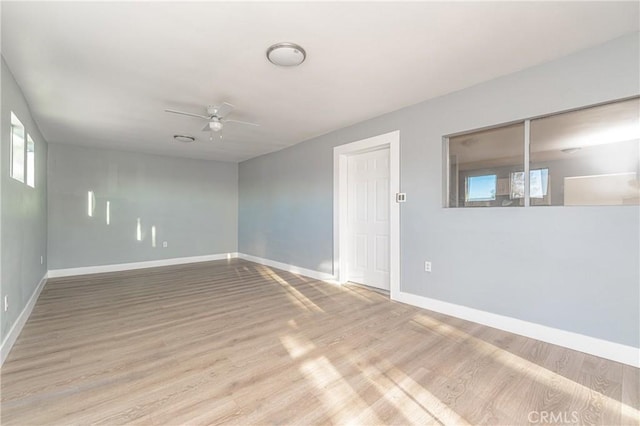 empty room featuring ceiling fan and light wood-type flooring