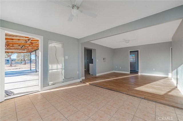 unfurnished room with ceiling fan and light hardwood / wood-style flooring