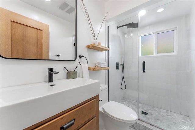 bathroom featuring vanity, toilet, and walk in shower