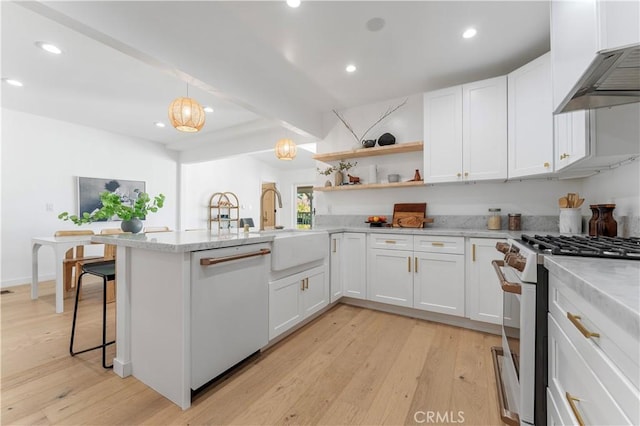 kitchen with a kitchen bar, white cabinetry, light hardwood / wood-style floors, and white appliances