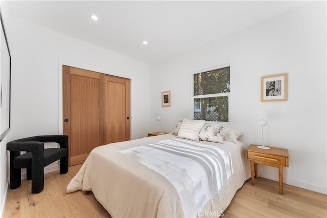 bedroom featuring light hardwood / wood-style flooring and a closet