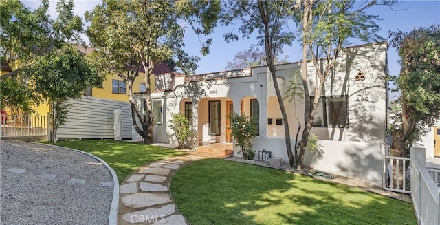 mediterranean / spanish house with a front lawn