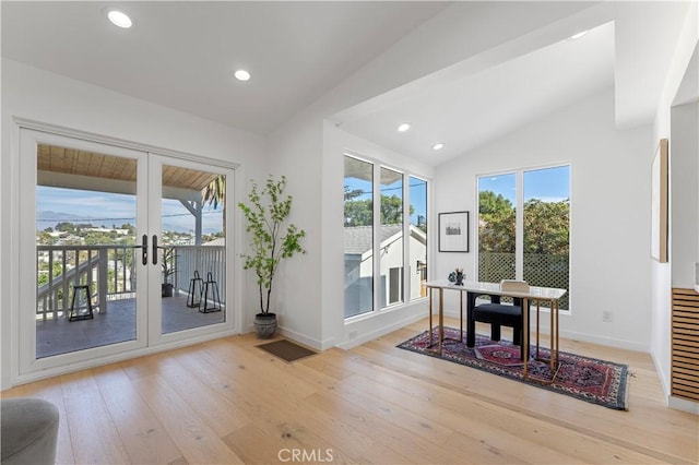 doorway to outside with french doors, light hardwood / wood-style floors, and vaulted ceiling