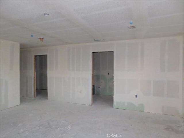 unfurnished room with concrete floors