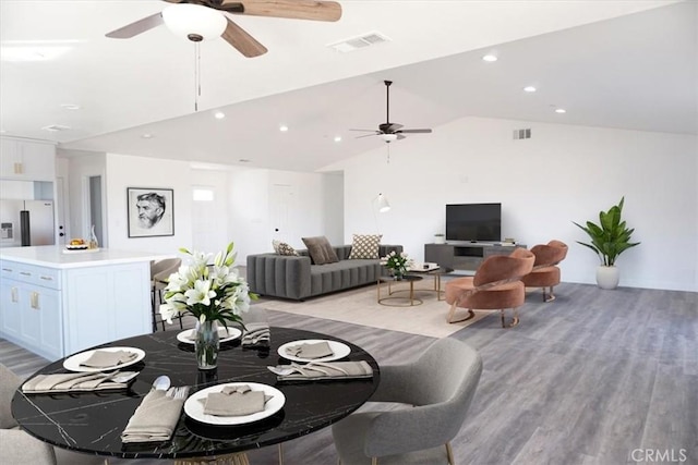 dining room with light hardwood / wood-style flooring and lofted ceiling