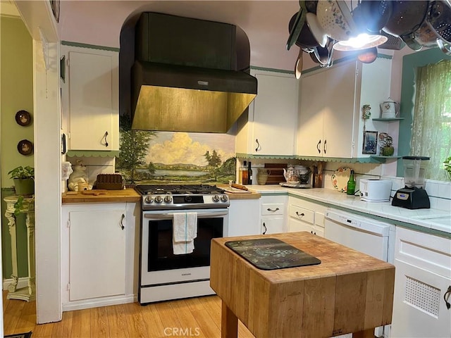 kitchen featuring white cabinetry, light wood-type flooring, white appliances, and extractor fan