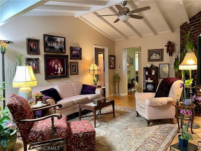 living room with vaulted ceiling with beams, light wood-type flooring, and ceiling fan