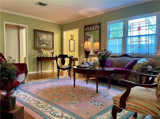 sitting room with wood-type flooring and crown molding