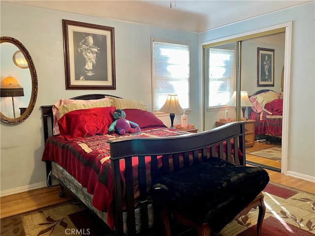 bedroom with hardwood / wood-style flooring and a closet