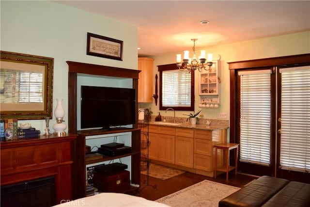 interior space featuring multiple windows, sink, and a chandelier