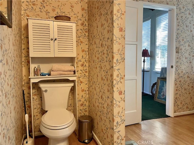 bathroom with toilet and hardwood / wood-style flooring