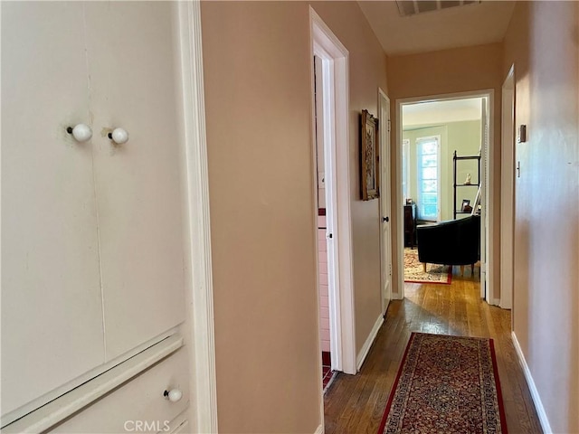 corridor featuring dark hardwood / wood-style flooring