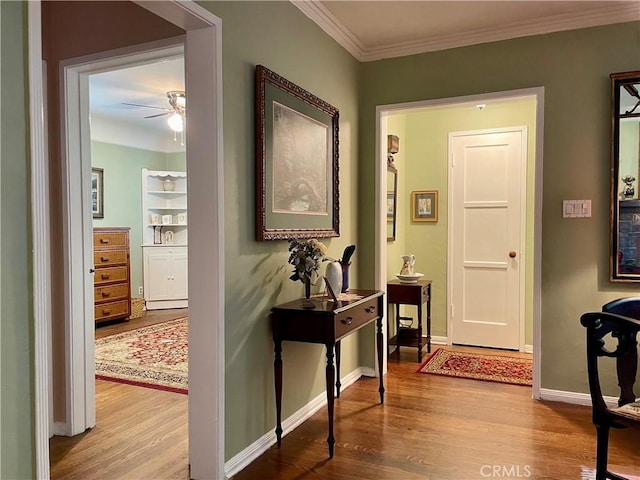 hallway featuring light wood-type flooring and ornamental molding