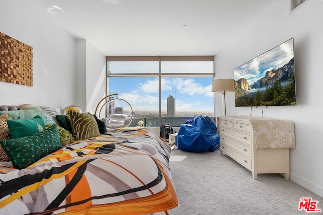 bedroom with light colored carpet and expansive windows