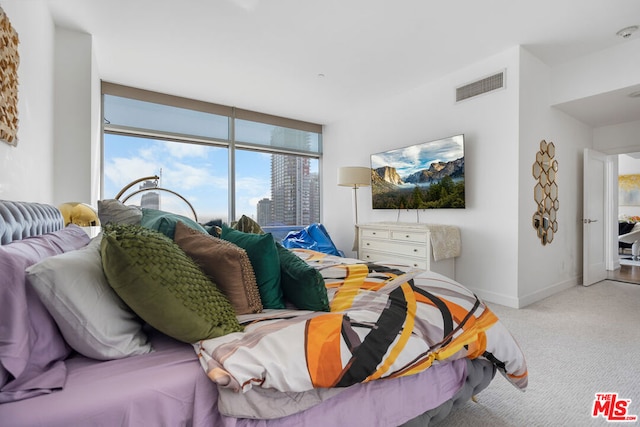 bedroom featuring light colored carpet