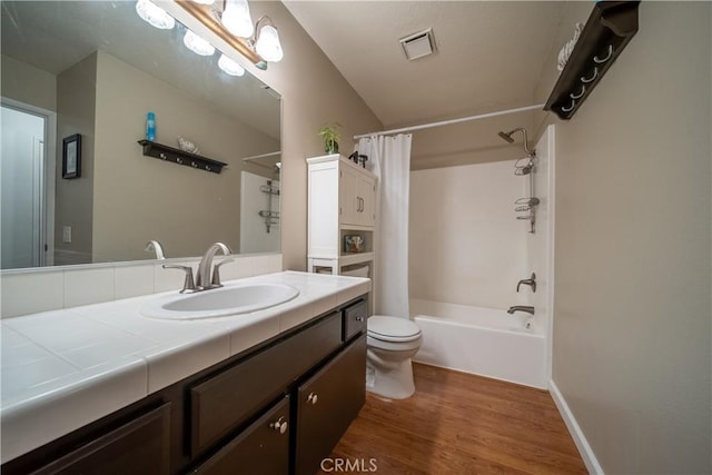 full bathroom with toilet, shower / bath combo with shower curtain, vanity, and hardwood / wood-style flooring