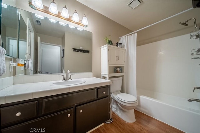 full bathroom featuring vanity, toilet, wood-type flooring, and shower / bath combo with shower curtain