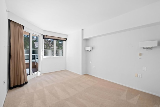 empty room with baseboards and light carpet