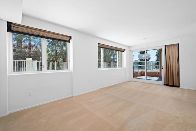 empty room with baseboards and light carpet