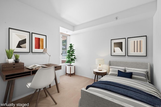 bedroom with baseboards and light carpet