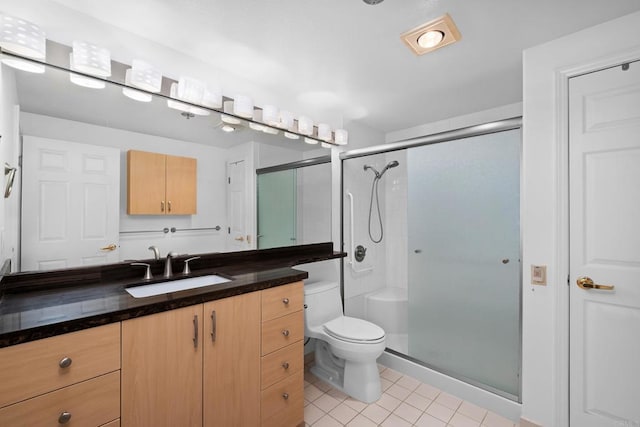 full bathroom featuring tile patterned floors, vanity, toilet, and a stall shower